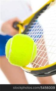 Closeup on tennis player balancing ball on racket