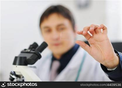 Closeup on test sample in hand of male researcher