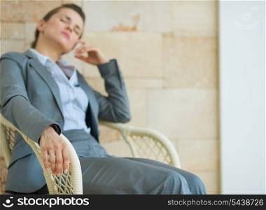 Closeup on tired business woman relaxing on chair