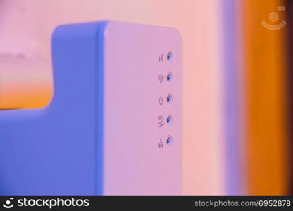 Closeup on WiFi repeater signal connection status led lights. The device is in electrical socket on the wall. It help to extend wireless network in home or office.