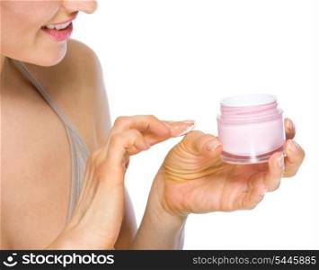 Closeup on woman applying creme on hand