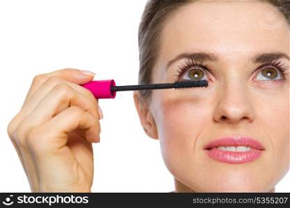 Closeup on woman applying mascara