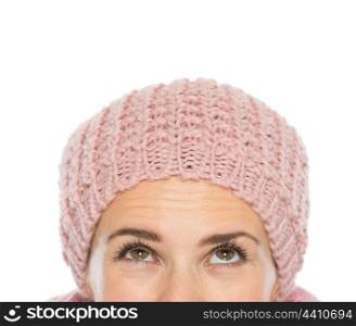 Closeup on woman head with knit hat looking up