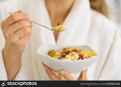 Closeup on woman in bathrobe eating healthy breakfast