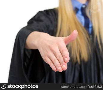 Closeup on woman in graduation gown stretching hand for handshake