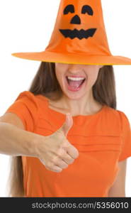 Closeup on woman in Halloween hat over eyes showing thumbs up