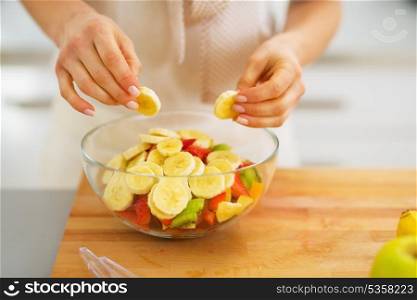 Closeup on woman making fruits salad