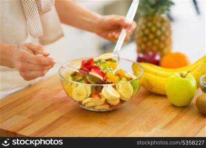 Closeup on woman making fruits salad