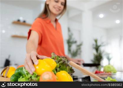 Closeup on woman preparing vegetable salad in kitchen at home. Focus on hands