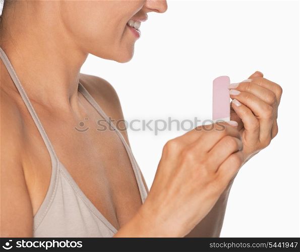 Closeup on woman using nail file