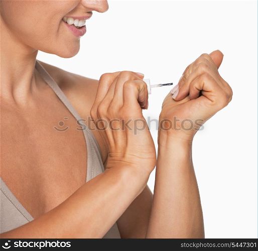 Closeup on woman using nail polish