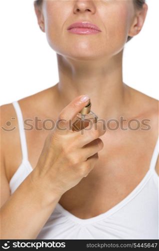 Closeup on young woman applying perfume