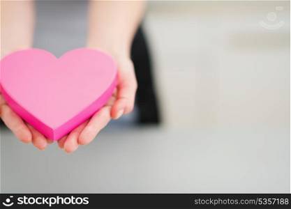 Closeup on young woman decorative heart