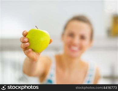 Closeup on young woman giving apple