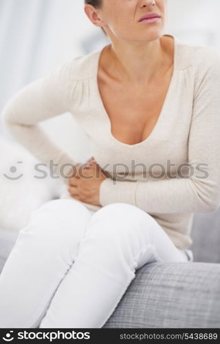 Closeup on young woman having stomach pain