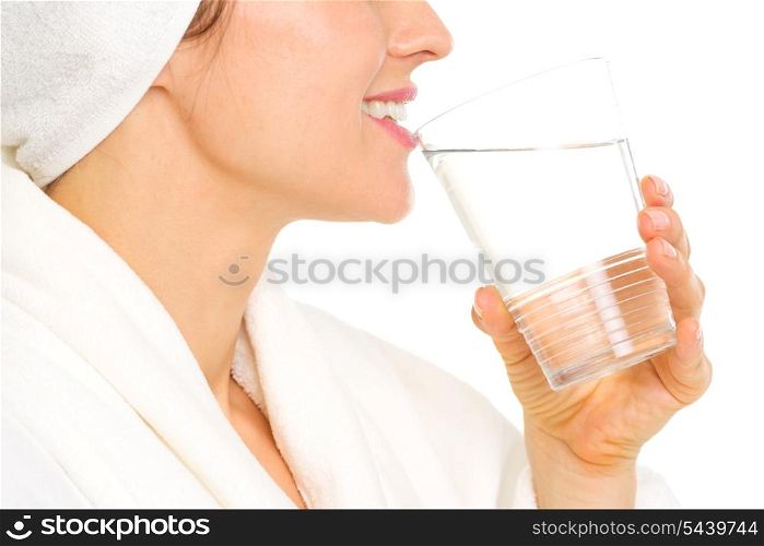 Closeup on young woman in bathrobe drinking water