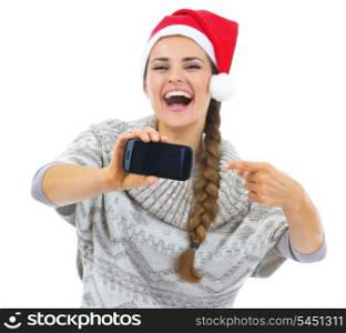 Closeup on young woman in sweater and christmas hat pointing on cell phone