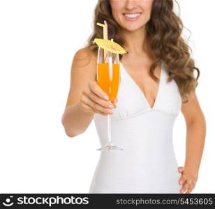 Closeup on young woman in swimsuit giving cocktail