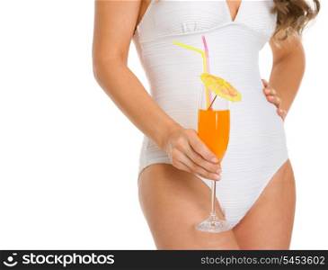 Closeup on young woman in swimsuit holding cocktail