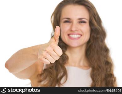 Closeup on young woman showing thumbs up