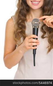 Closeup on young woman tapping on microphone to check sound