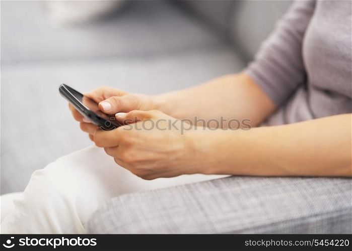 Closeup on young woman writing sms