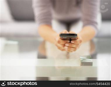Closeup on young woman writing sms