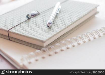 Closeup pen and green covered notebook, stock photo