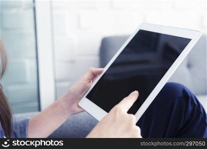 Closeup people using tablet with blank screen in office. Business and technology concept.
