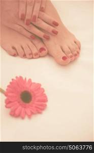 Closeup photo of a female feet and hands at spa salon on pedicure and manicure procedure