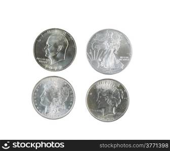 Closeup photo of a Morgan, Peace, Eisenhower and American Eagle Silver Dollars isolated white