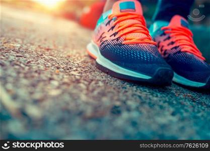 Closeup photo of a women&rsquo;s running shoes, female on the workout in sunny day, life energy, health and body care, sportive life concept