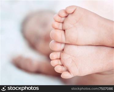 Closeup photo of an adorable baby&rsquo;s feet, little barefoot infant, body part, carefree healthy childhood, new life concept