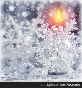 Closeup photo of beautiful silver Christmas time decoration, shiny snowflake with ball shape burning candle, luxury festive ornament