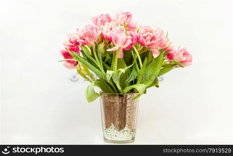 Closeup photo of big bunch of pink tulips against white background