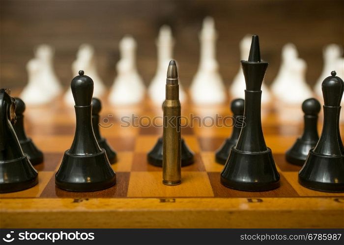 Closeup photo of bullet standing on place of queen chess piece