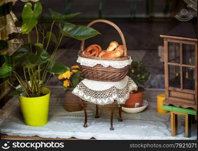 Closeup photo of buns in decorative basket on table