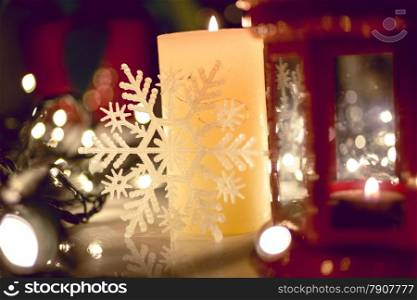 Closeup photo of burning candle on decorated Christmas table