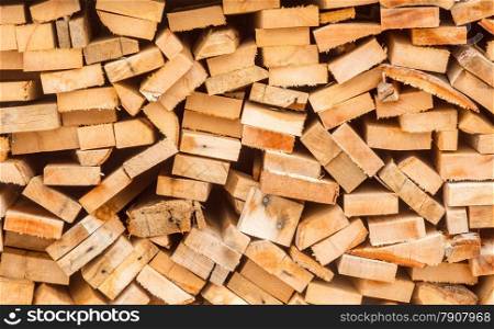 Closeup photo of chopped wood stacked in pile for winter