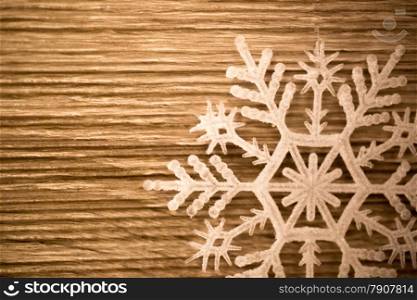 Closeup photo of decorative white show flake on wooden board
