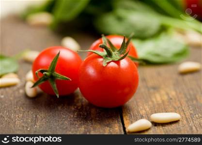 closeup photo of delicious fresh cherry tomates with pine nuts