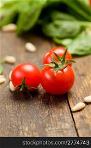 closeup photo of delicious fresh cherry tomates with pine nuts