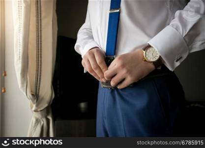 Closeup photo of elegant man wearing suspenders