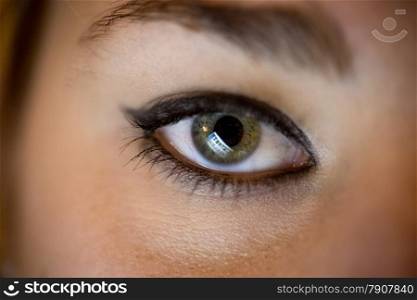 Closeup photo of female eye with computer screen reflecting in it