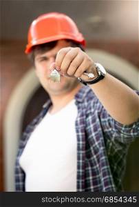 Closeup photo of foreman holding keys from new house