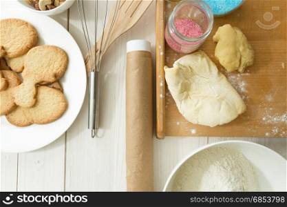 Closeup photo of freshly baked cooking next to kitchen utensils on white background