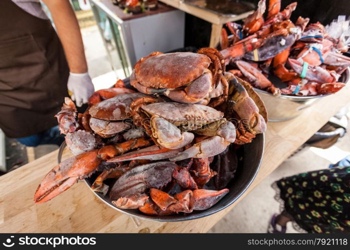 Closeup photo of frozen crabs and lobster claws at restaurant kitchen