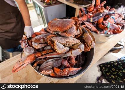 Closeup photo of frozen crabs and lobster claws at restaurant kitchen