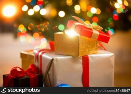 Closeup photo of glowing magic Christmas gift boxes