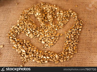 Closeup photo of handprint on pile of golden nuggets lying on table